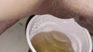 Girl pisses in red solo cup
