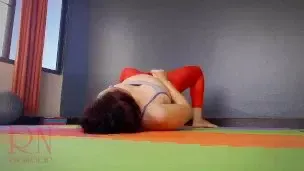 Regina Noir. A woman in yoga leotards practices yoga in the gym. Transparent red leotard yoga.